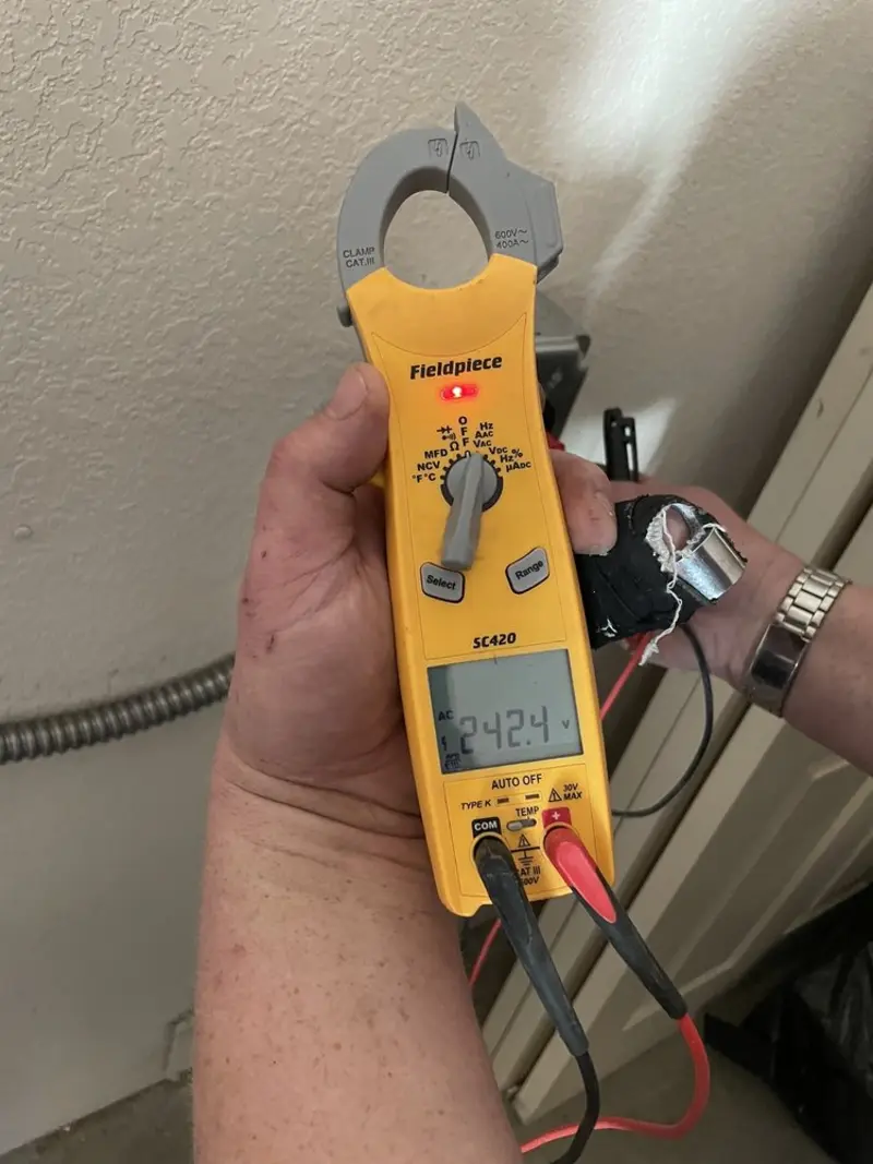 Voltage testing with clamp meter during Outlet Installation in Clifton Park